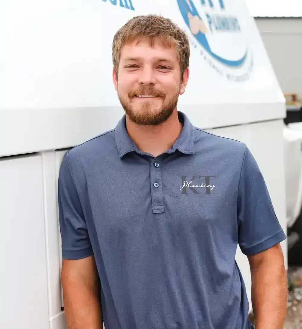 tech without hat in front of truck hands in pockets