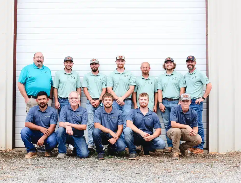 two rows of team techs in front of garage door