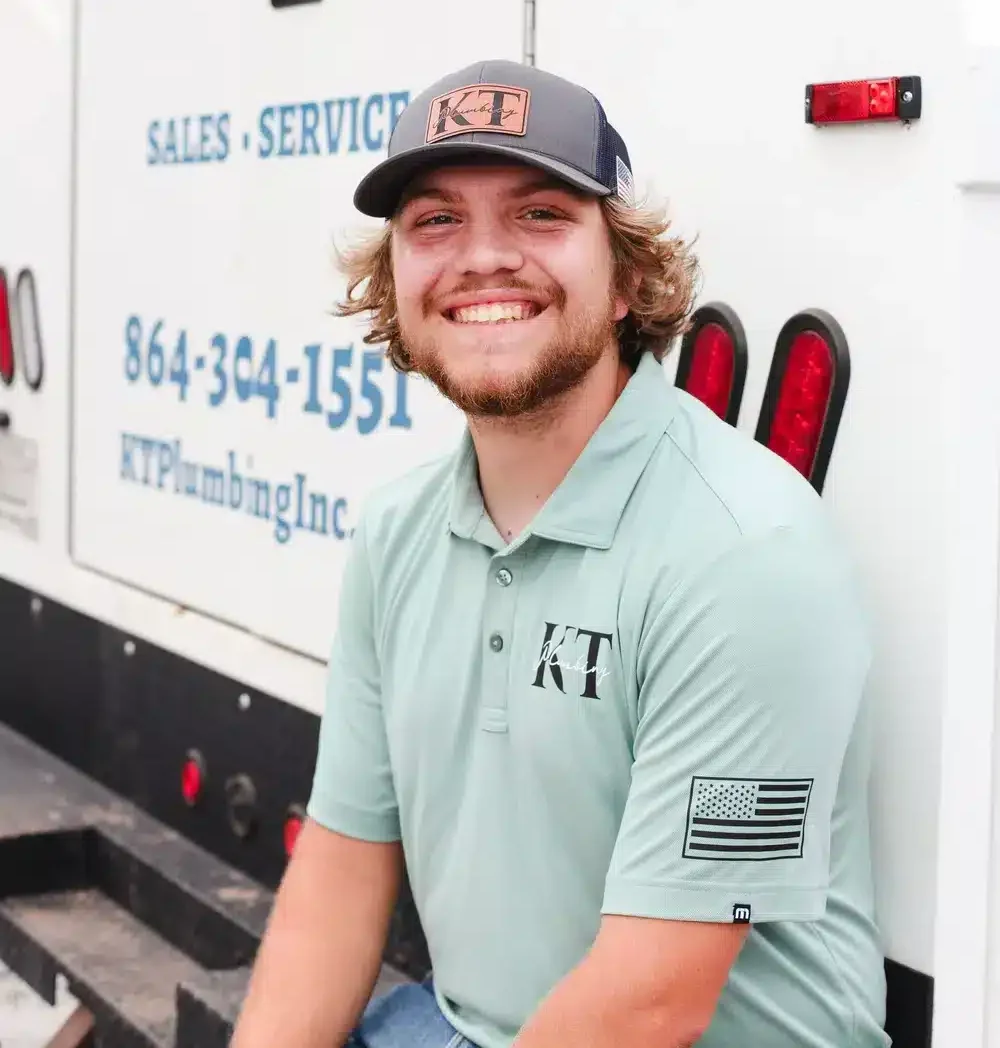 smiling tech in front of truck