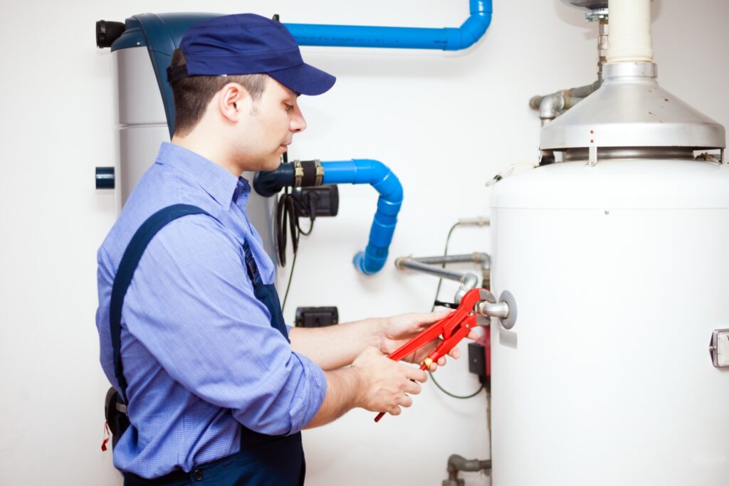 plumber performing water heater maintenance in greer sc